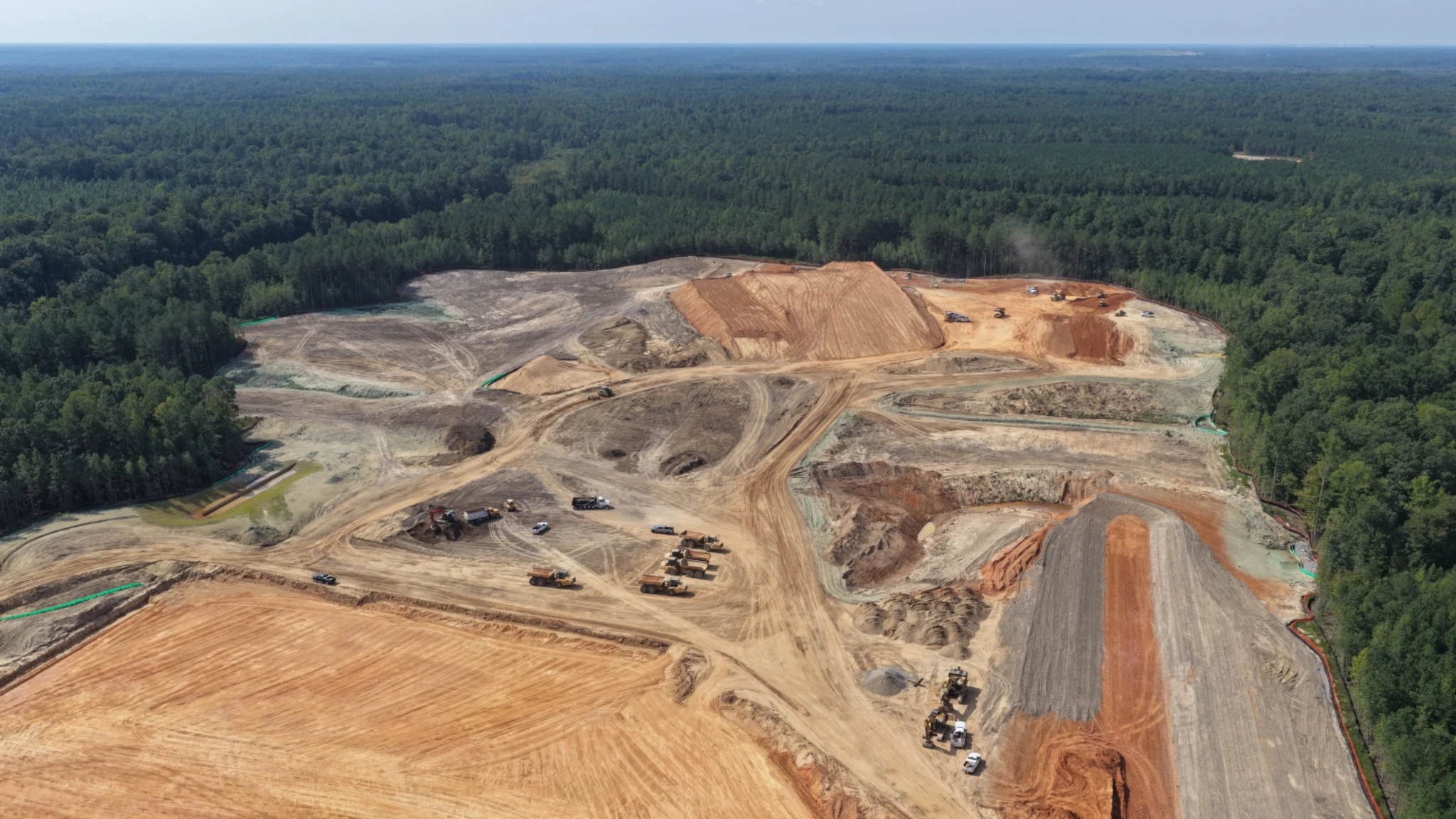 Long-range view preserving the full scale of current site-preparation work.
