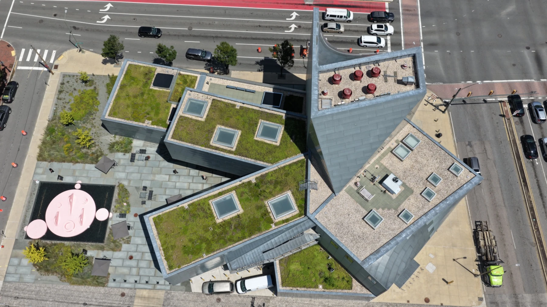 Downward aerial view showing roof geometry, skylights, green roofs and courtyard plaza