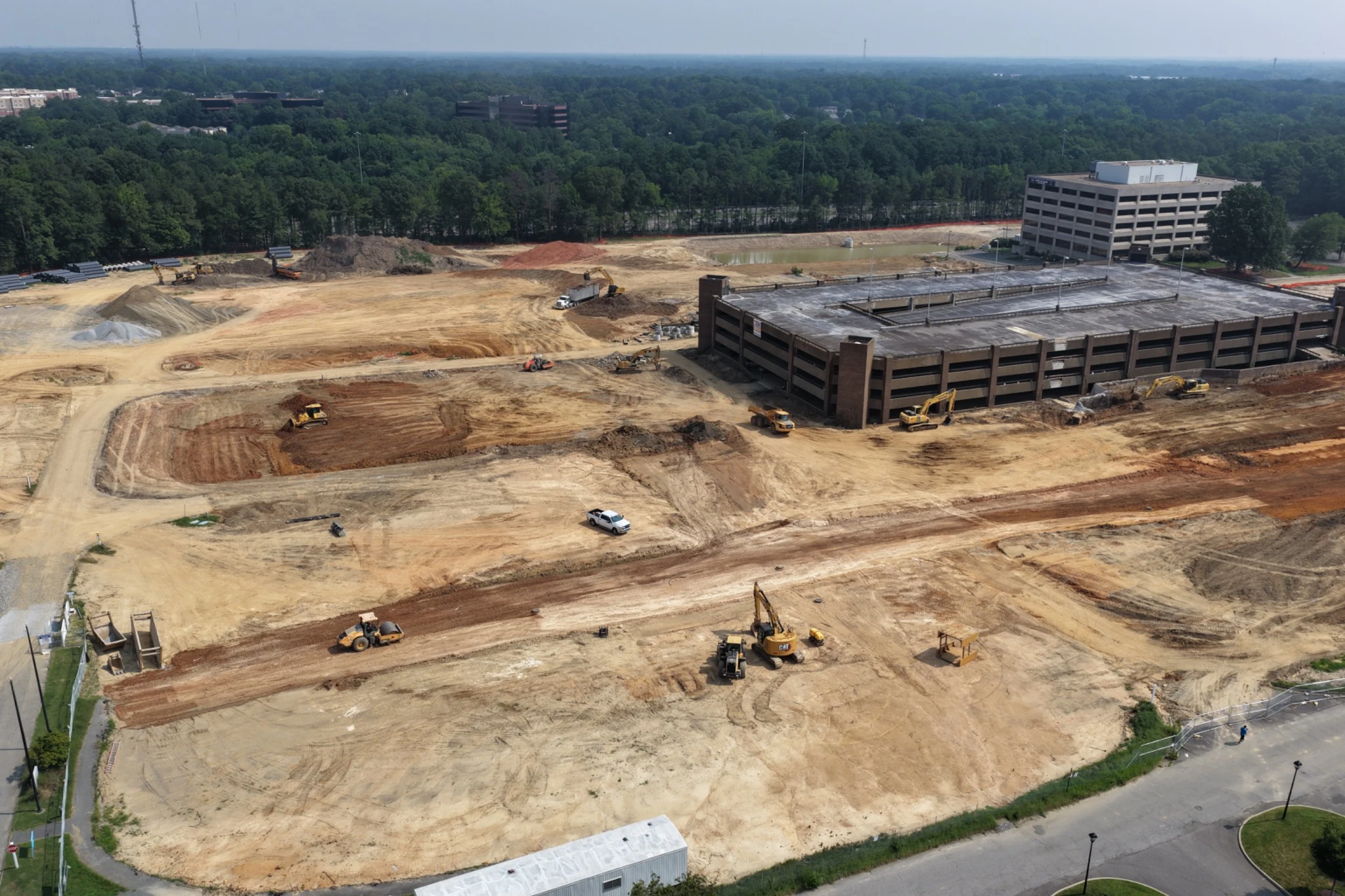 Oblique aerial view across Midtown site preparation and remaining parking structure