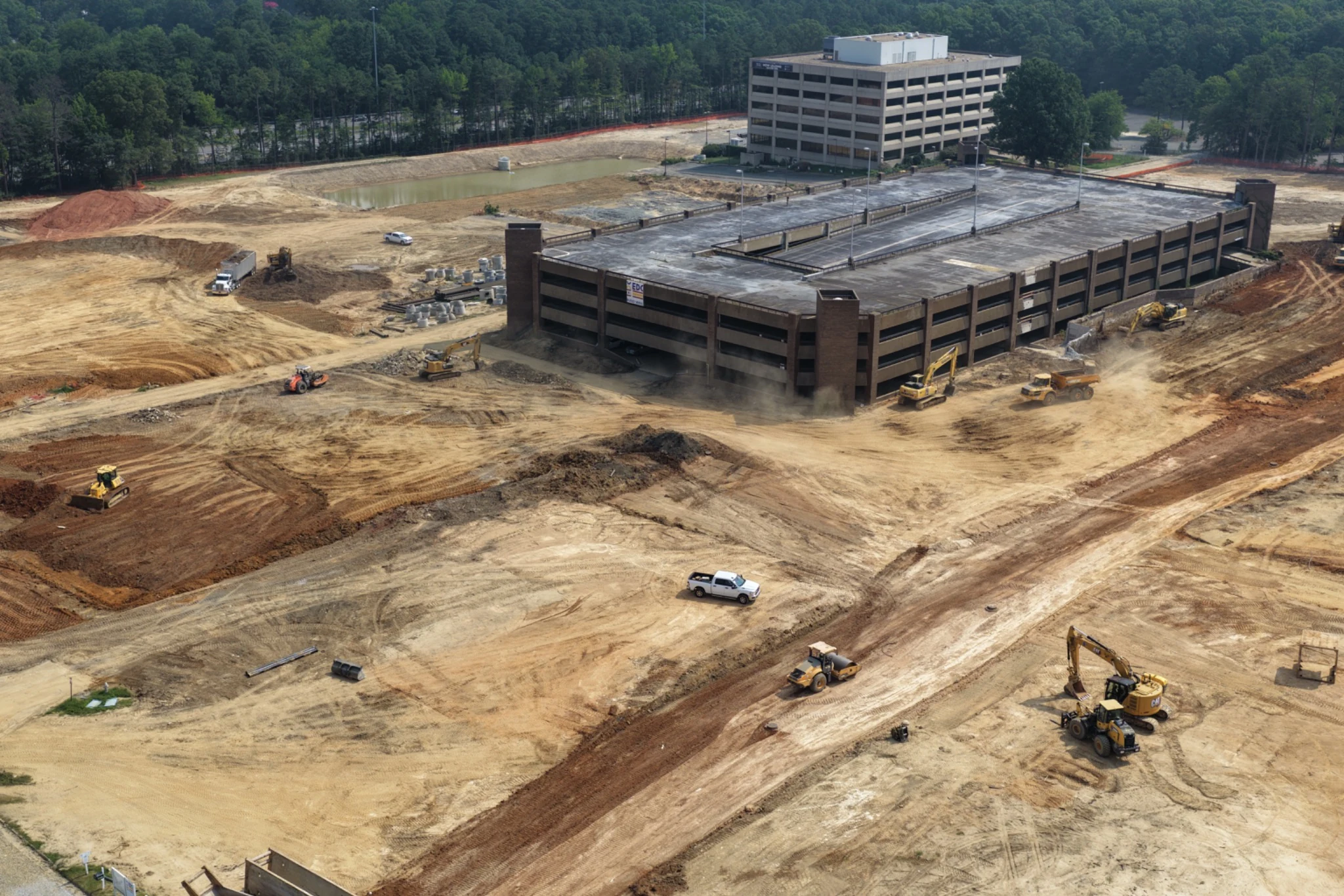 Close Midtown site-preparation view with equipment and remaining parking structure