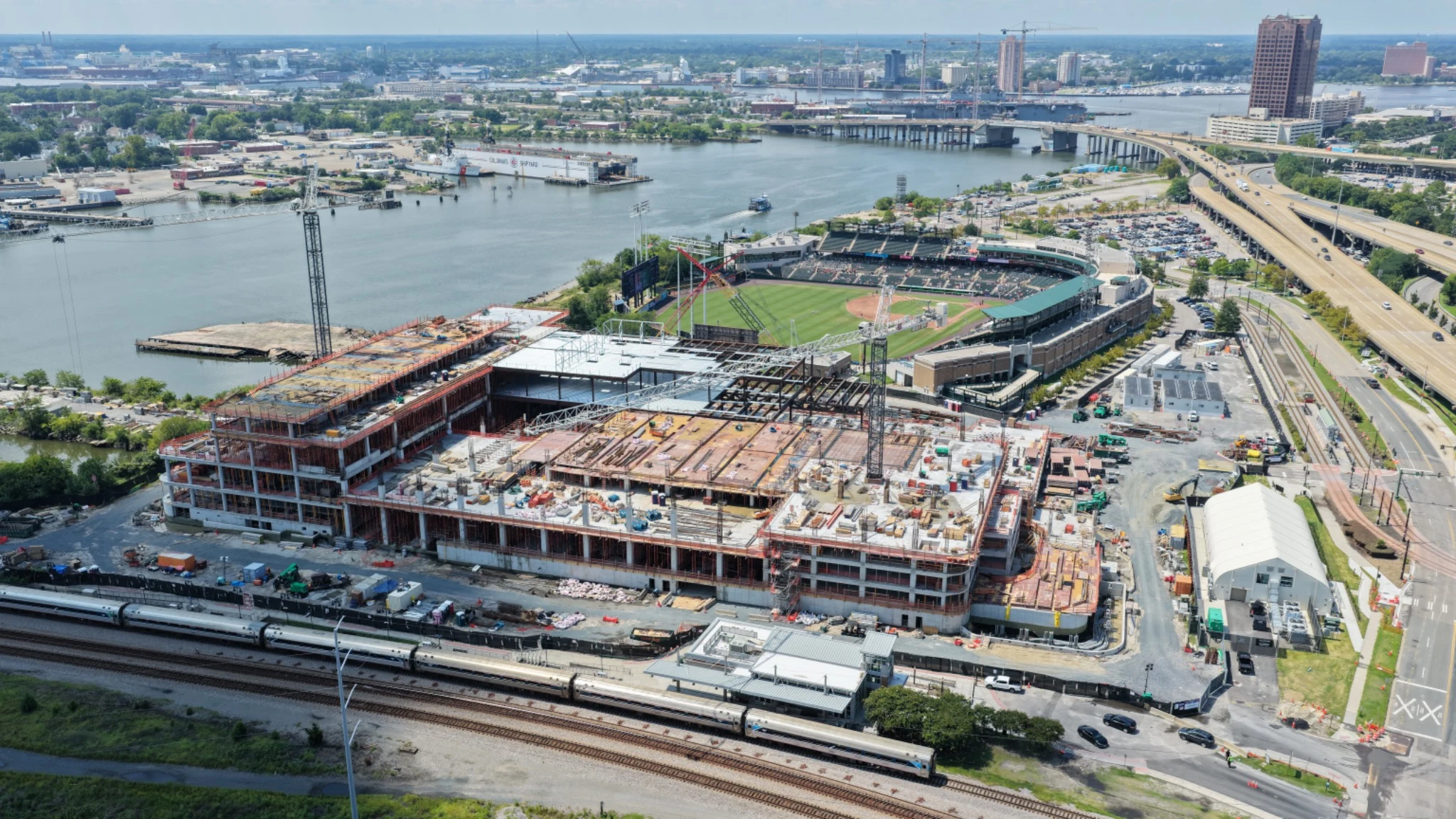 Elevated oblique view of Norfolk casino, Harbor Park, highway and river
