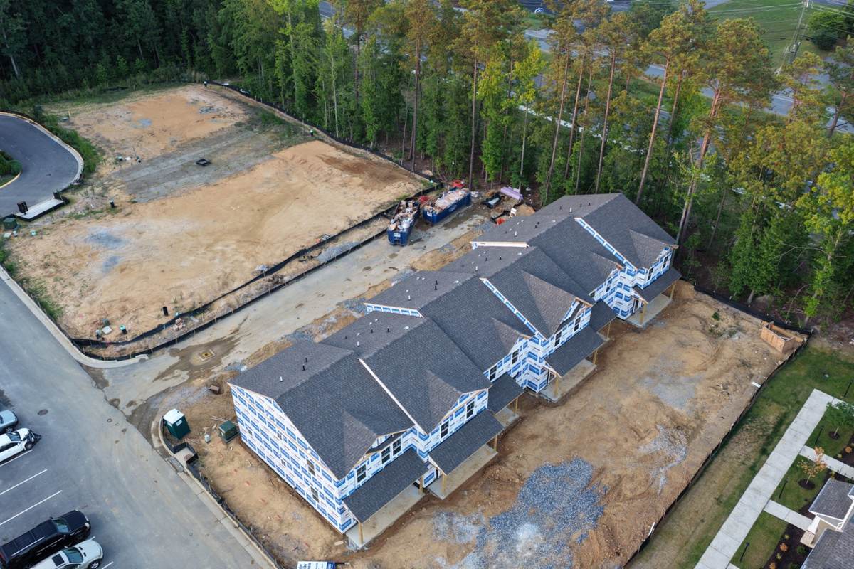 Residential construction drone photography showing wood-frame progress and site conditions